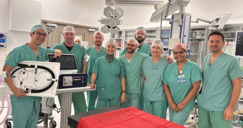 Three women standing in front of an Enterprise Ireland building. They are smiling at the camera. One woman wears a dark jacket over a black top and green skirt, the second wears glasses and a sleeveless blush top, and the third wears a white lace blouse with a navy skirt.